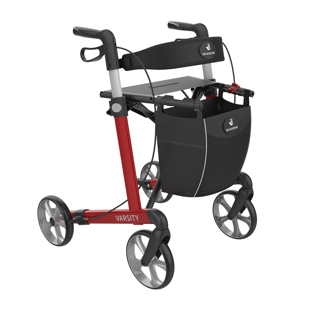 The Rehasense Varsity Folding Aluminum Rollator has a red and black frame, four large wheels for easy movement, hand brakes, a seat, and a detachable front storage bag.