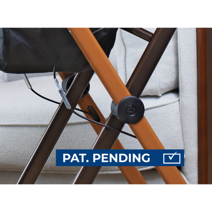 Close-up of intersecting orange and brown metal legs on the Rehasense Pixel Indoor Rolling Walker near a beige couch, showing an attached cable and a blue PAT. PENDING label with a check mark icon at the bottom.