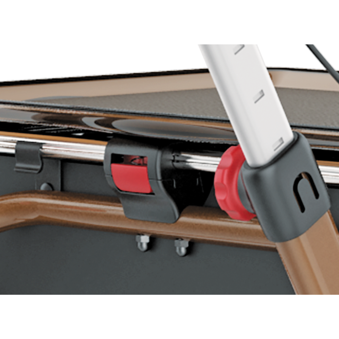 Close-up of the Rehasense Pixel Indoor Rolling Walker, highlighting its red knob, black and red locking mechanism, and metal parts on a brown frame.