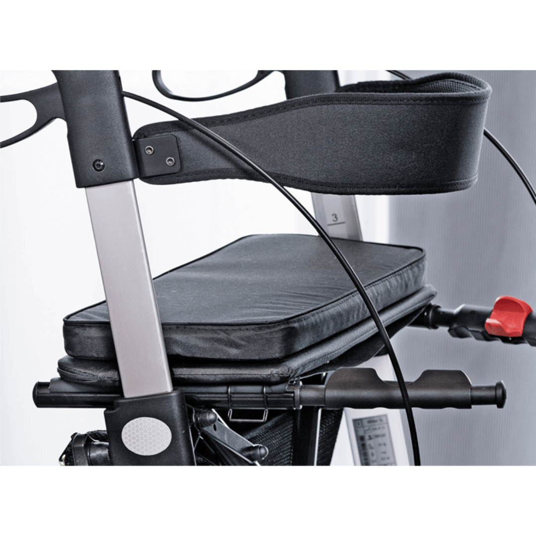 Close-up of a black and silver Rehasense Varsity HD XL Bariatric Lightweight Rollator with padded seat, backrest, support handles, and control cables against a neutral background.