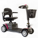 The FDA-cleared Reyhee Cruiser Portable Electric Mobility Scooter boasts a black padded seat, armrests, and handy front basket. Its four-wheel design ensures stability, while the foldable tiller allows easy steering. The gray body is stylishly accented with pink touches.