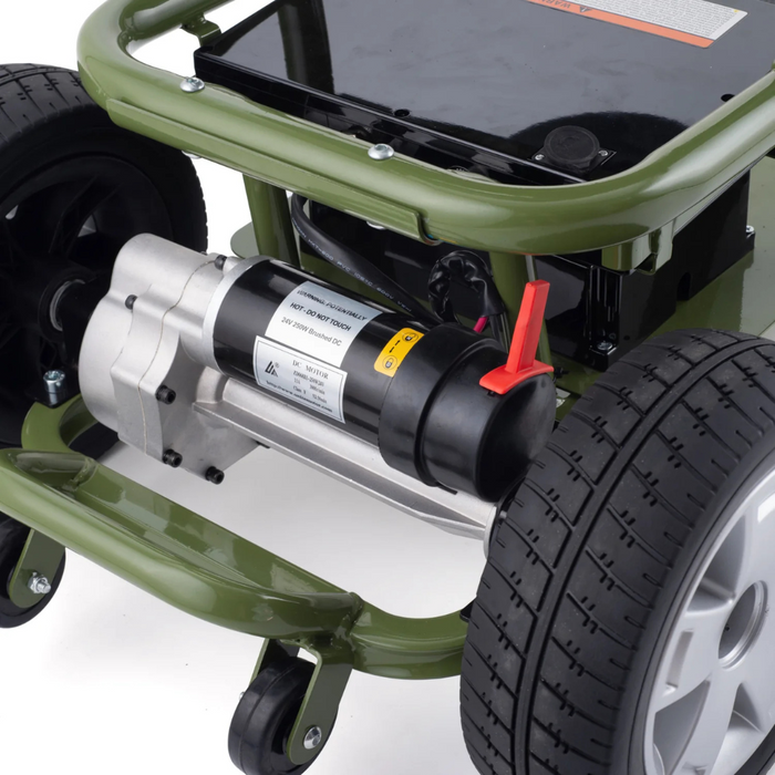 Close-up of a green lawn mowers underside revealing its black motor, sturdy frame, red handle, and deep-tread wheels similar to those on the Reyhee EXO Portable 4-Wheel Mobility Scooter for enhanced traction. The motor features a label with specifications.