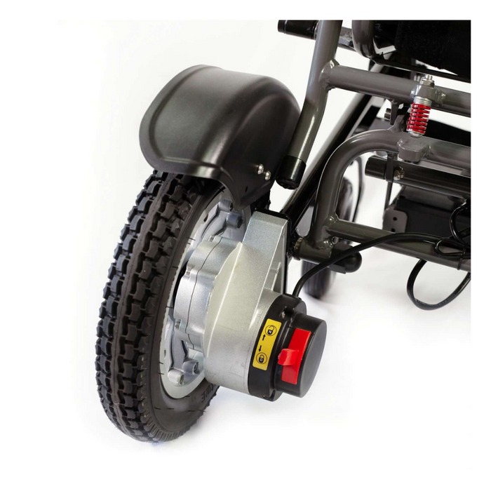 Close-up of a Reyhee Roamer Folding Long Range Electric Wheelchair wheel with a thick tire, sturdy metal motor housing, and control knob with yellow and red markings. The frame highlights mobility, showcasing a red spring mechanism attached.