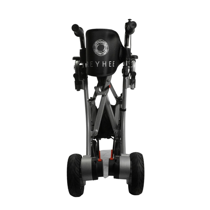 Viewed from the front, the folded black and silver Reyhee Superlite 3-in-1 Electric Foldable Wheelchair showcases its lightweight design with large sturdy wheels and handlebars. The seat displays REYHEE with a circular logo above it.