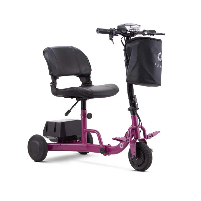 The Reyhee Triad Compact Folding Electric Mobility Scooter is a sleek purple model with three wheels, a black cushioned seat, and handlebars featuring a black front bag. It boasts a convenient Swap & Go Battery System located beneath the seat for effortless personal transportation.