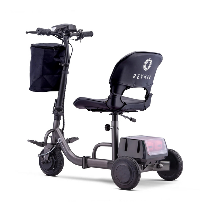 The Reyhee Triad Compact Folding Electric Mobility Scooter features three wheels, a padded seat with REYHEE on the back, rear storage, a black handlebar basket, and a small footrest. Its Swap & Go Battery System ensures seamless rides.