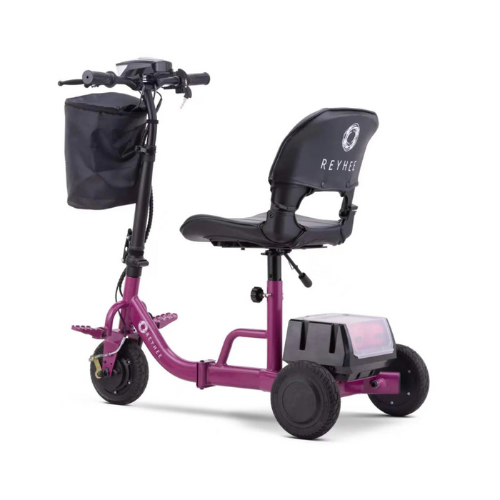 The Reyhee Triad Compact Folding Electric Mobility Scooter is red with three wheels, a black seat and backrest, handlebars with controls, a front black basket, rear storage, and features a portable Swap & Go Battery System for ultimate convenience.