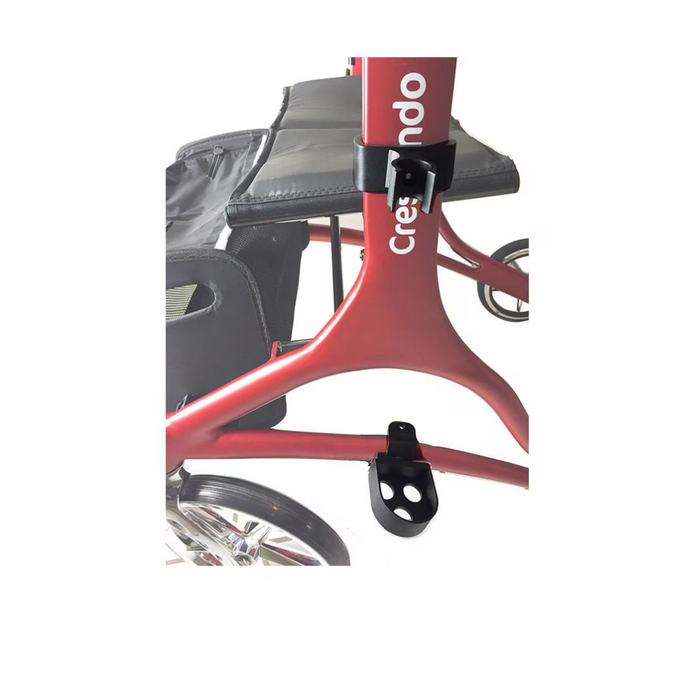 Close-up of a red-and-black Rhythm Crutch Holder for the 955 and 956 Rollators with a padded seat, labeled Creando. It features two visible wheels and a curved frame, designed for support and stability—perfect for those in need of reliable mobility aid solutions.