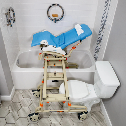 The Rifton Wave Pediatric Shower Chair, in blue and beige with wheels, is placed over a toilet and extends into the bathtub, enabling easy transfers for those with mobility needs.