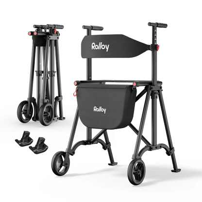 The Rolloy Compact Master Bariatric 2-Wheel Walker with Seat in black is shown fully open and folded. It features a storage bag, seat, and includes two small accessory pieces visible on the side.