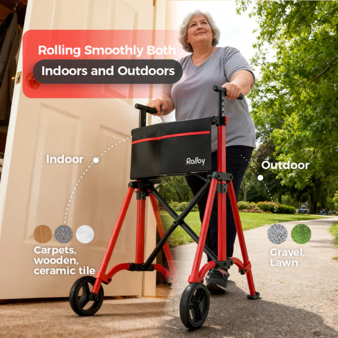 An older woman uses the Rolloy Ultra-Compact Master Bariatric Walker with 2 Wheels, easily moving from indoors to outdoors. The image shows its versatility on carpets, wood and tile floors, gravel, and lawns.