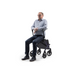 A man in glasses and a blue shirt is seated, facing forward, on a Rollz FLEX 2 Lightweight Rollator Walker featuring four wheels, a compact design, and an XL storage bag. The white background highlights this mobility aid.