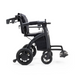 The Rollz Motion Electric 3-in-1 Rollator, Transport Chair & Powerchair in a sleek black design is foldable and features ergonomic armrests and footrests. Its large rear wheels and smaller front wheels ensure easy maneuverability, captured in a profile view.