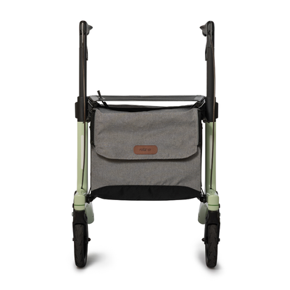 A front view of the Rollz Air Lightweight Folding Carbon Rollator (10.4 lbs) with a gray storage bag between the light green and black handles. The bag features a leather logo patch.