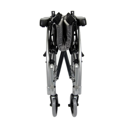 A front view of the folded Karman S-Ergo 115 Ergonomic Ultralite Transport Wheelchair showcases its silver frame and grey seat. Its sleek, compact design ensures easy storage or transport, while small front wheels enhance convenience and mobility.