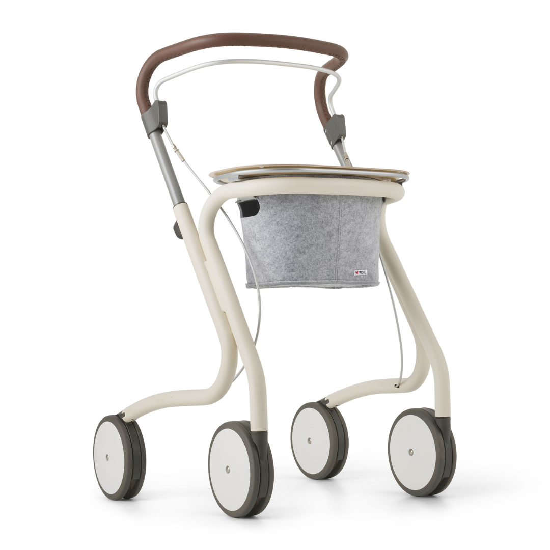The byACRE Scandinavian Butler At-Home Rollator features a modern beige frame, brown curved handle, large white wheels, and a gray felt storage pouch for effortless mobility at home.