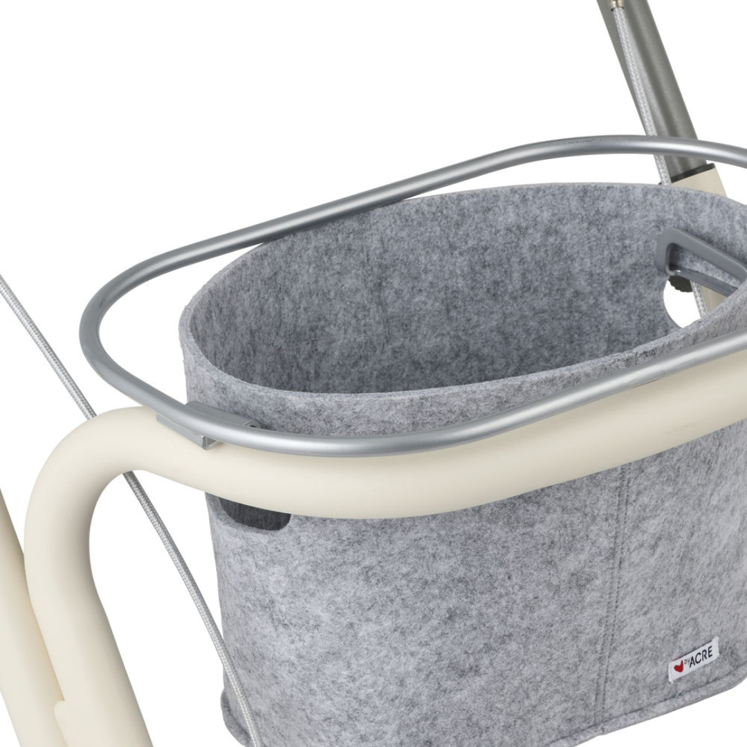 Close-up of the byACRE Scandinavian Butler At-Home Rollator with a light grey felt basket, perfect for storing personal items. The basket features a small tag and is inspired by Scandinavian Butler style.