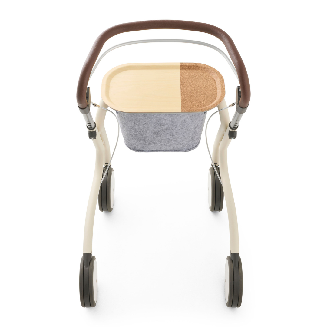 Overhead view of the byACRE Scandinavian Butler At-Home Rollator, showcasing a modern look with brown and beige tray, gray fabric basket, four wheels, and curved brown handles—ideal for daily home convenience.