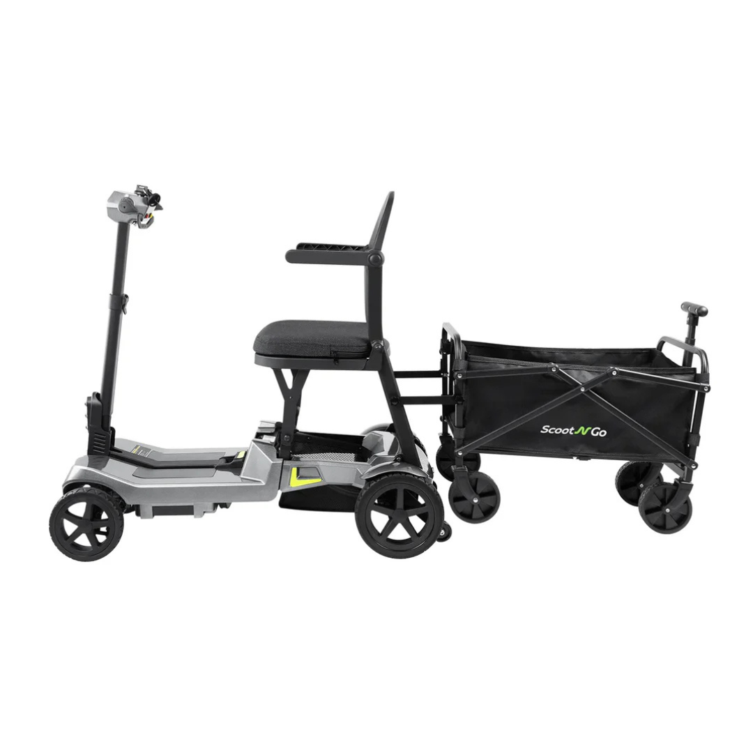 The ScootNGo Lite Portable Folding Scooter is a compact gray scooter with a seat, handlebars, and four wheels. It's attached to a black collapsible wagon with two large wheels and a small handle. See the spec table for full details.