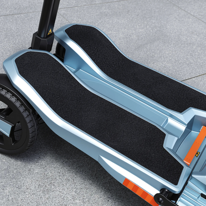 Close-up of the ScootNgo Voyager Lightweight Folding Scooter’s dual black textured footrests, metallic blue frame, and large rear wheel, shown on a light gray tiled pavement.