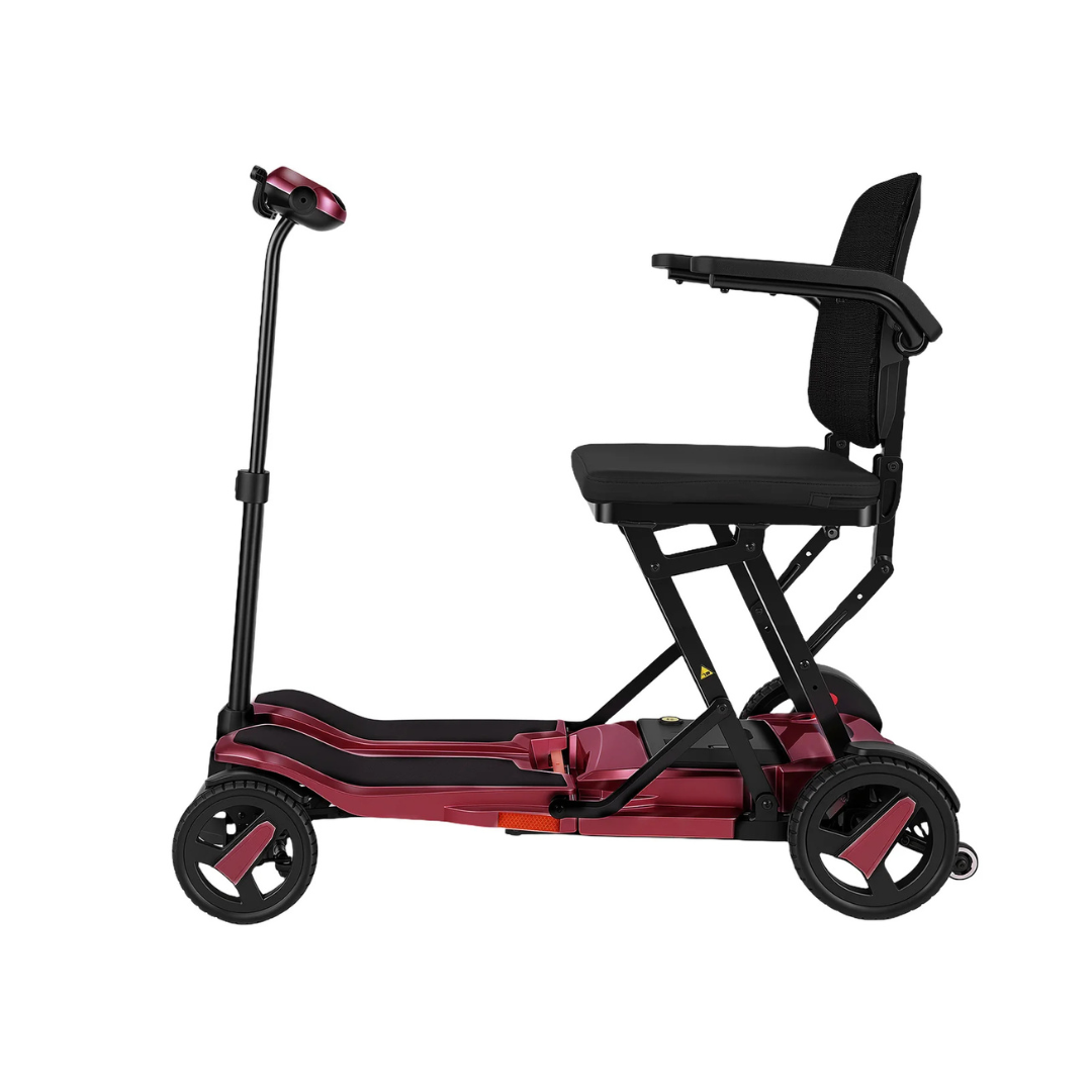 The ScootNgo Voyager Lightweight Folding Scooter is a compact, three-wheeled mobility scooter with a maroon and black frame, black seat with armrests, handlebars, and is shown from the side against a white background.