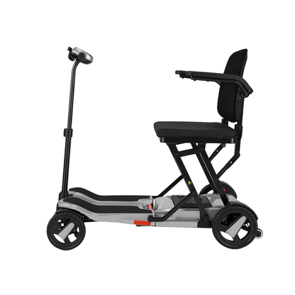 Side view of the ScootNgo Voyager Lightweight Folding Scooter—a compact three-wheel mobility scooter with a padded seat, armrests, slim footboard, and upright handlebars, designed for easy personal transportation.
