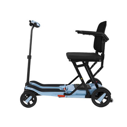 The ScootNgo Voyager Lightweight Folding Scooter is a light blue and black three-wheel scooter shown from the side, featuring a seat with armrests and a vertical handlebar.
