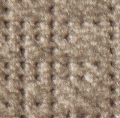 Close-up of a textured beige carpet with a grid pattern and soft, raised fibers—an inviting addition to relax beside your Golden Tech PR527 Cloud Recliner With Lift Assist & Twilight - SM/MD. The carpet’s neutral tone creates a cozy, clean atmosphere.