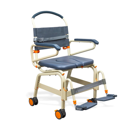 The ShowerBuddy SB6C Bariatric Rolling Shower Chair features a padded seat, armrests, footrests, safety belt, and four orange-wheeled casters for enhanced mobility and accessible patient care.