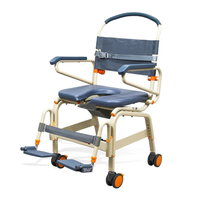 The ShowerBuddy SB6C Bariatric Rolling Shower Chair is a lightweight, portable shower and commode chair with padded seat/backrest, armrests, foldable footrests, and four orange-accented wheels for easy mobility and support in any roll-in shower.
