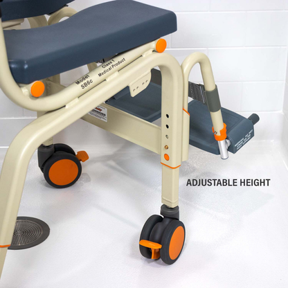 The ShowerBuddy SB6C Roll-in shower chair Commode with blue padding, orange accents, and wheels is shown on a white bathroom floor. An arrow highlights its leg’s ADJUSTABLE HEIGHT settings.