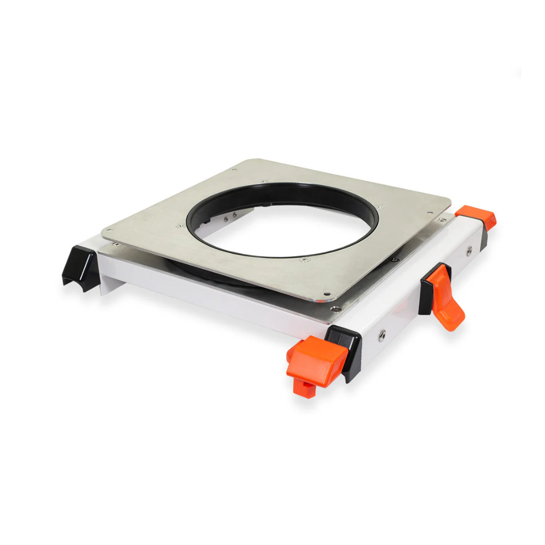 A rectangular metal base with a central circular cutout and orange-black locking levers, designed as an accessory for ShowerGlyde® Transfer Benches to support hard-plastic or padded seats for improved bathing comfort.