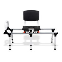 ShowerGlyde SG2 Sliding Transfer Bench features a black padded seat and backrest, white frame, safety rail, and height-adjustable legs—perfect for safe tub and toilet transfers in bathroom setups.