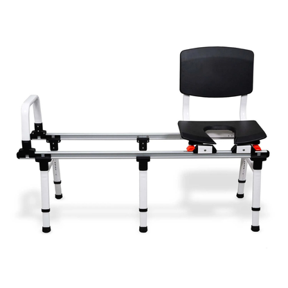 The ShowerGlyde SG2 Sliding Transfer Bench features an aluminum frame, adjustable legs, black backrest and armrest, plus an open-front seat—ideal for safe transfers between toilet-adjacent tubs or as a commode bench.