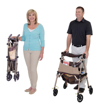 A woman holds a folded Signature Life Elite Travel Rollator while a man stands beside an open one loaded with items. Both are smiling against a white background.