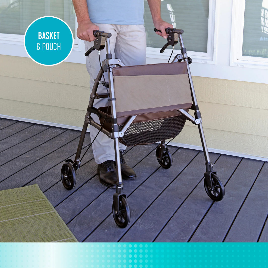 A person stands behind the Signature Life Elite Travel Rollator, featuring a tan pouch and mesh basket, on a wooden deck outside a house. A circular label reads BASKET & POUCH.