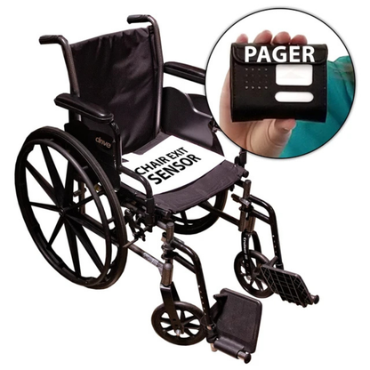 A wheelchair with a Chair Exit Sensor pad on the seat, and a hand holding the SmartCaregiver Pager device that receives alerts from the sensor—part of the SmartCaregiver Pager Bed/Chair Exit Alert & Systems.
