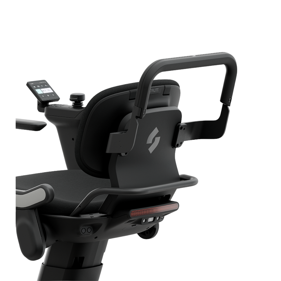 Close-up of the Smart Push Handle | Strutt ev1 Compatible, showcasing the modern black electric wheelchair’s ergonomic handles with Smart Push Handle technology, padded seat, and an integrated touchscreen display on the backrest for seamless caregiver control—all set against a white background.