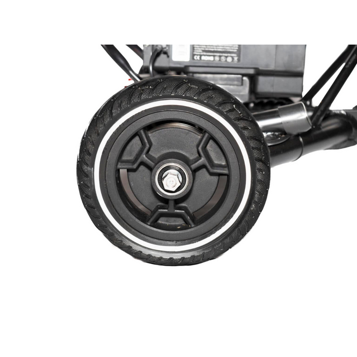 Close-up of a black wheel with a textured tire on the Glion SnapnGO Ultralight Folding Mobility Scooter. The wheel has a central metal bolt, ideal for various terrains with three speed settings.