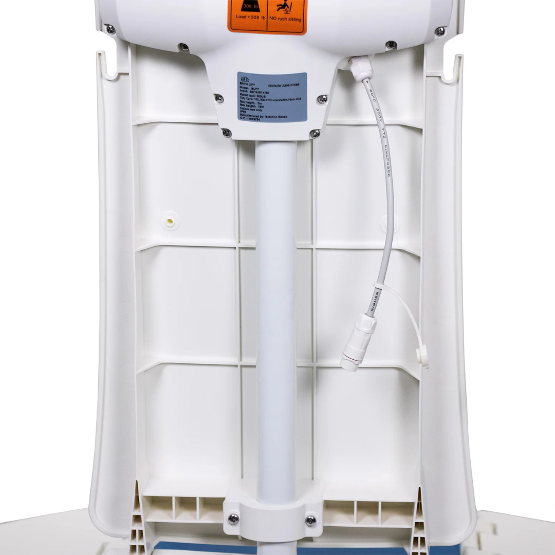 Close-up of a SolutionBased BathLyft - Battery-Powered Bathtub Lift Chair, showing the back with pole, base, wiring, and a caution label. The electrical cable runs along the pole to a connector, highlighting its key components.