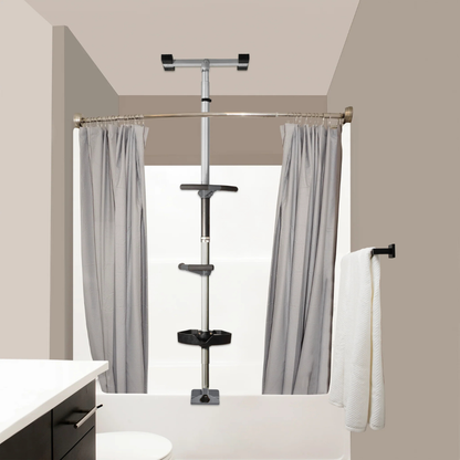 A bathroom with a curved shower rod, gray curtains, the Stander Wonder Premium Bathtub Fall Prevention Pole, and a silver tension shower caddy in the corner; a white towel hangs on a black towel rack nearby.