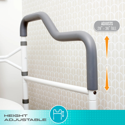 A close-up of the Stander Wonder Toilet Safety Rails & Standing Aid, a white height-adjustable support rail with gray handle (28–36 in.), shown by patterned wallpaper. Ideal for bathroom stability or as a standing aid.