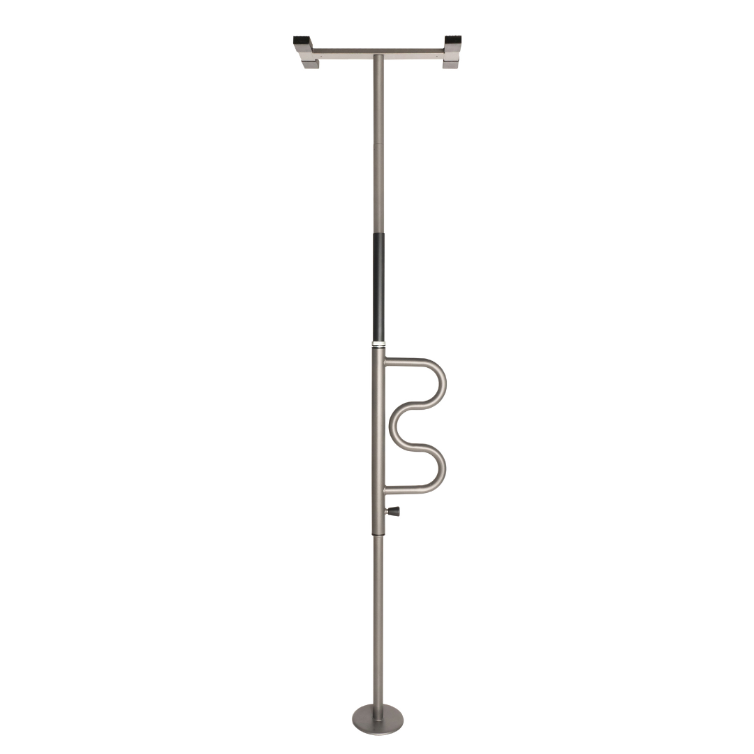 The Stander Wonder Pole is a freestanding metal safety pole with a horizontal top handle and curved support, designed to assist sit-to-stand transitions and enhance bathroom mobility for fall prevention at home.