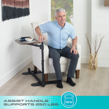 A smiling older man sits in a white armchair, holding the Stander Wonder Tray Plus – TV Tray & Standing Aid. Text reads: Assist Handle Supports 250 lbs. A vase and decor are visible in the background.