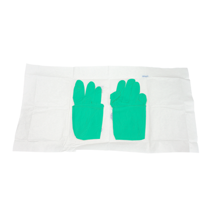 A pair of green Dynarex SafeTouch Sterile Nitrile Powder-Free Surgical Gloves seen side by side on a white disposable sheet, viewed from above.