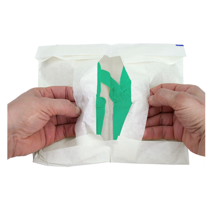 Two hands open a white sterile paper package to reveal a pair of green Dynarex SafeTouch Sterile Nitrile Powder-Free Surgical Gloves inside.