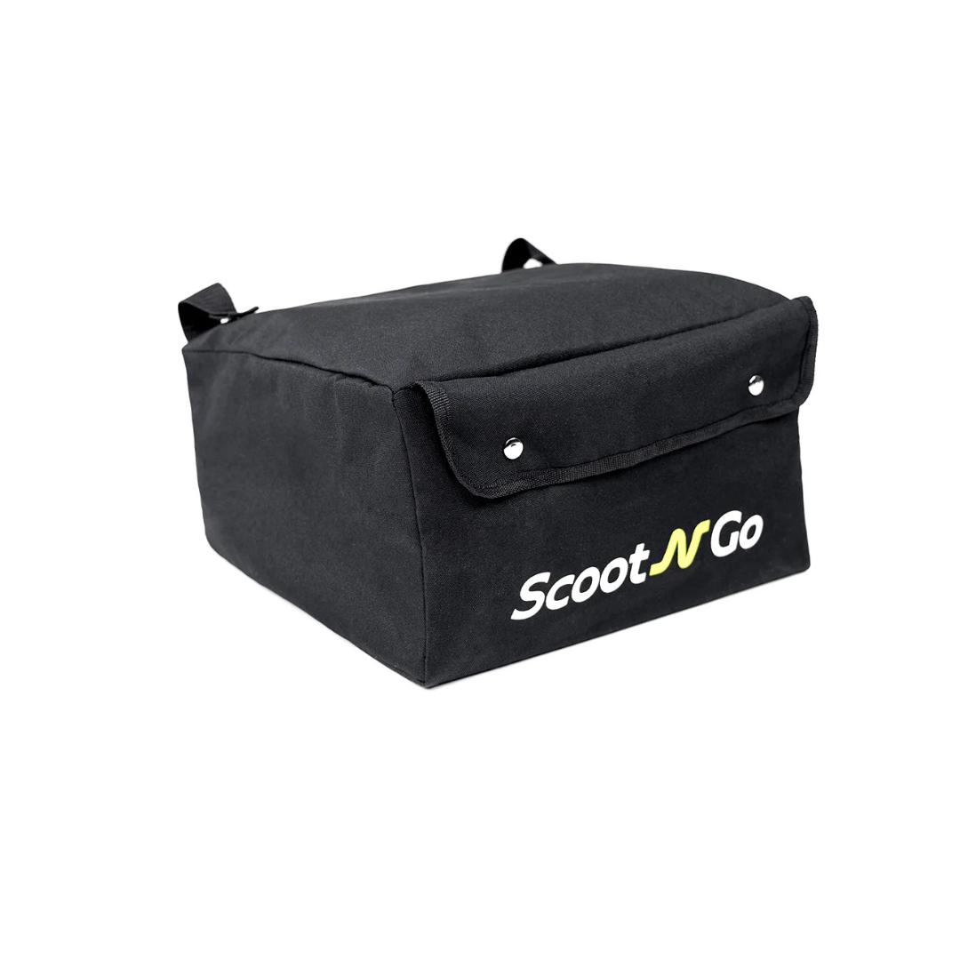 The Storage Bag For ScootNgo Lite/Voyager is a black, rectangular fabric bag with a flap secured by snap buttons. It features the ScootNGo logo in white and yellow on the front and is designed as an ideal accessory for your Voyager Mobility Scooter or Lite Mobility Scooter. The bag includes two small handle loops on each side for convenient carrying.