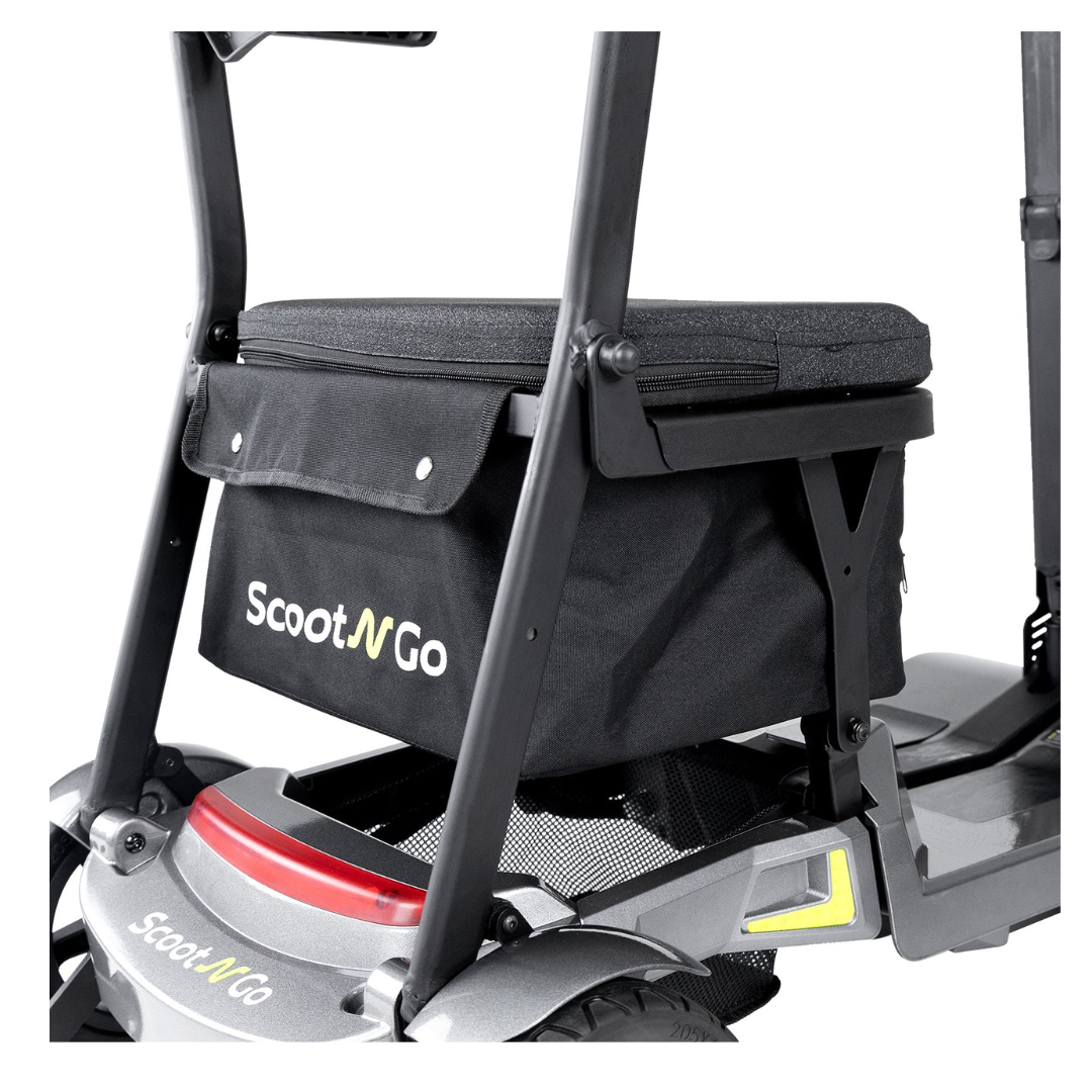 Close-up of a black Storage Bag For ScootNgo Lite/Voyager attached behind the seat of a Voyager Mobility Scooter, displaying the brand logo along with part of the scooter frame and wheel.