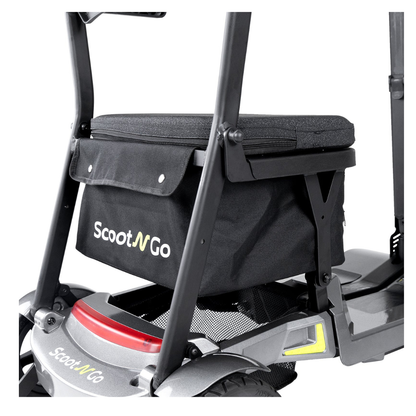 Close-up of a black Storage Bag For ScootNgo Lite/Voyager attached behind the seat of a Voyager Mobility Scooter, displaying the brand logo along with part of the scooter frame and wheel.