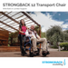 A woman smiles as she pushes an older man in a Strongback Mobility Excursion 12 Transport Wheelchair - Ultralight on a wooden deck. The chair, featuring built-in lumbar support, is surrounded by trees and a pergola, highlighting its ergonomic design for comfort.